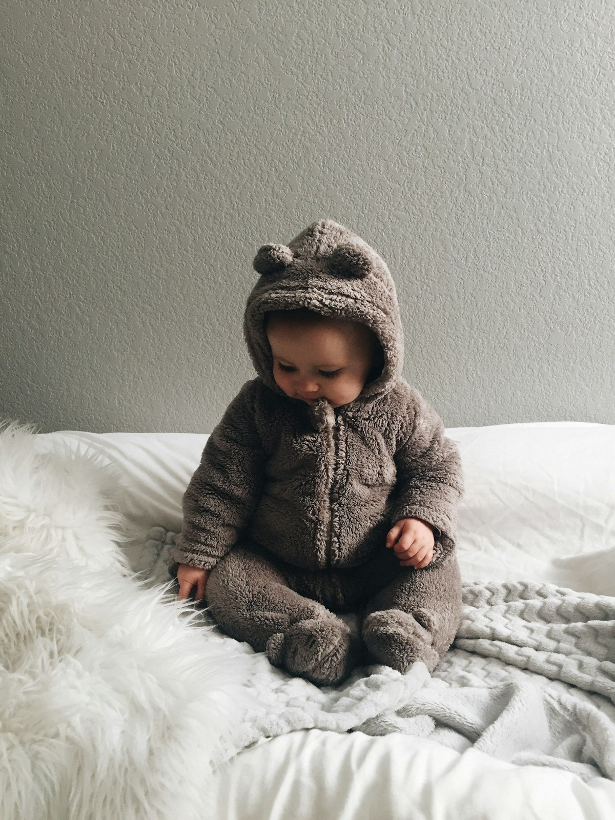 Baby seating on white textile