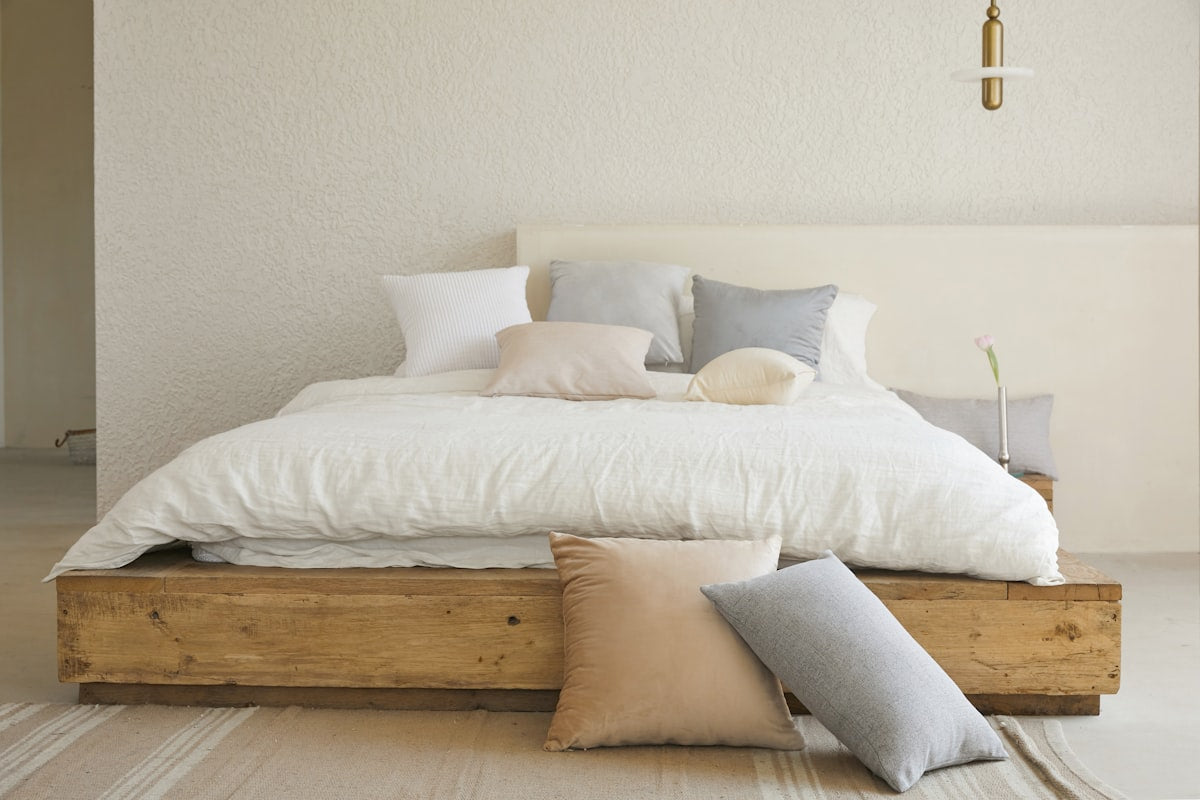 White pillow on a wooden bed frame