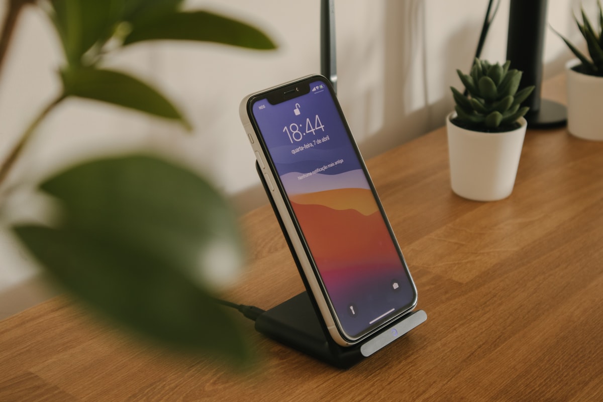 Black electronic device on brown wooden table