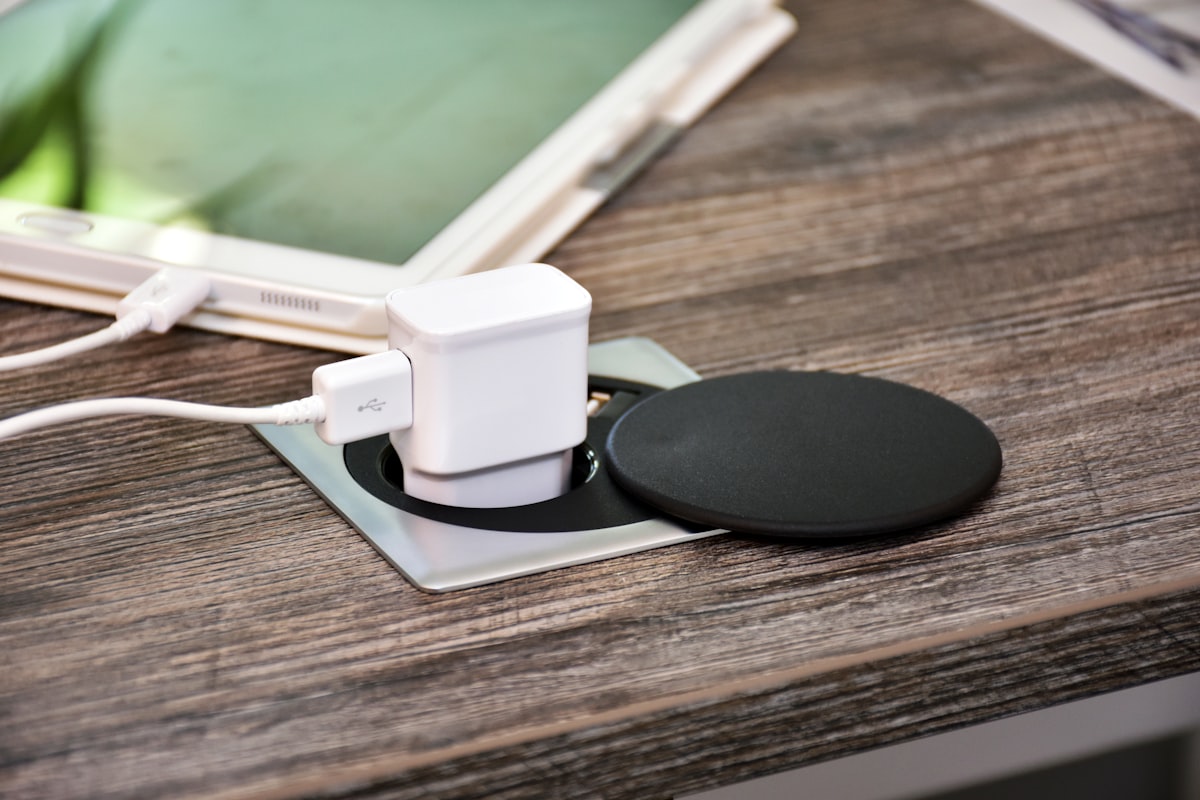 White charger adapter on a wooden table