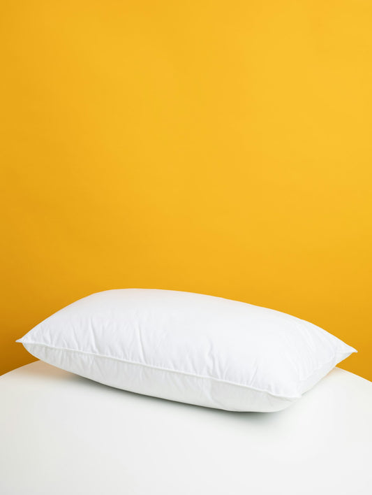 White pillow on a bed