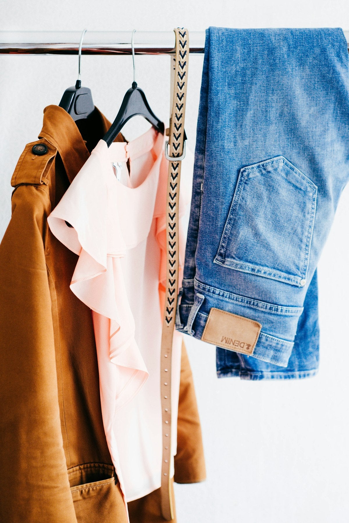 Women's four assorted apparel hanged on clothes rack
