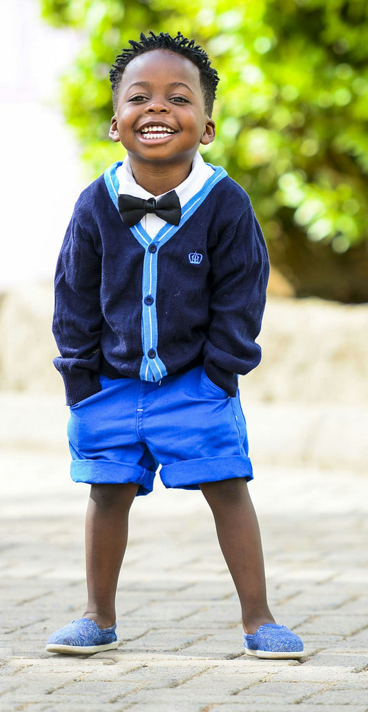 Boy standing on grey pavement