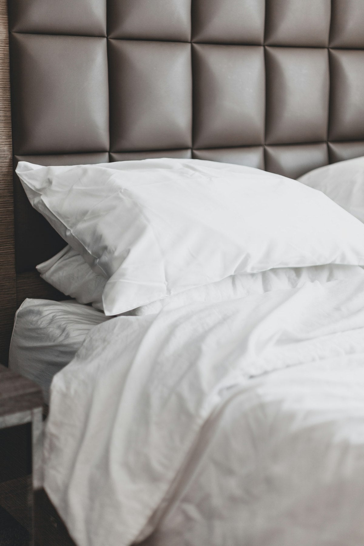 White bed pillow on bed frame