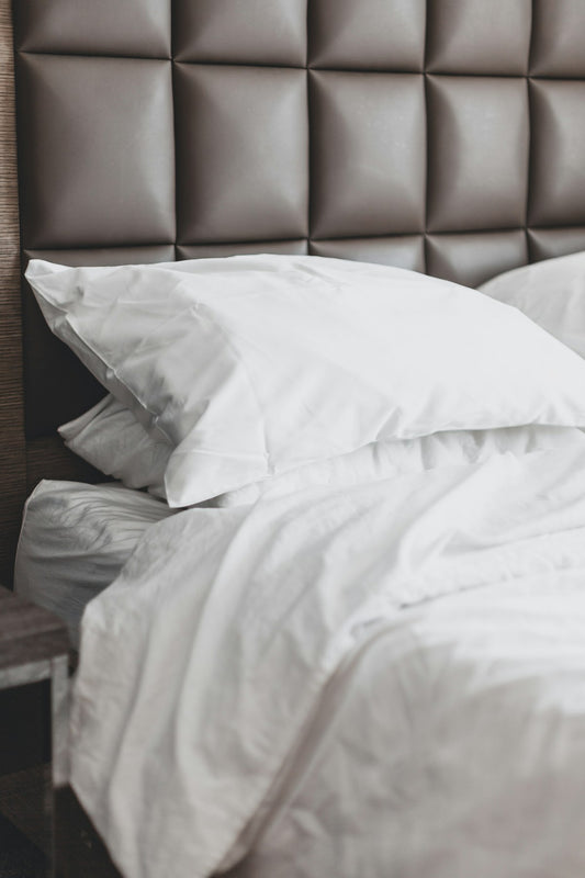 White bed pillow on bed frame
