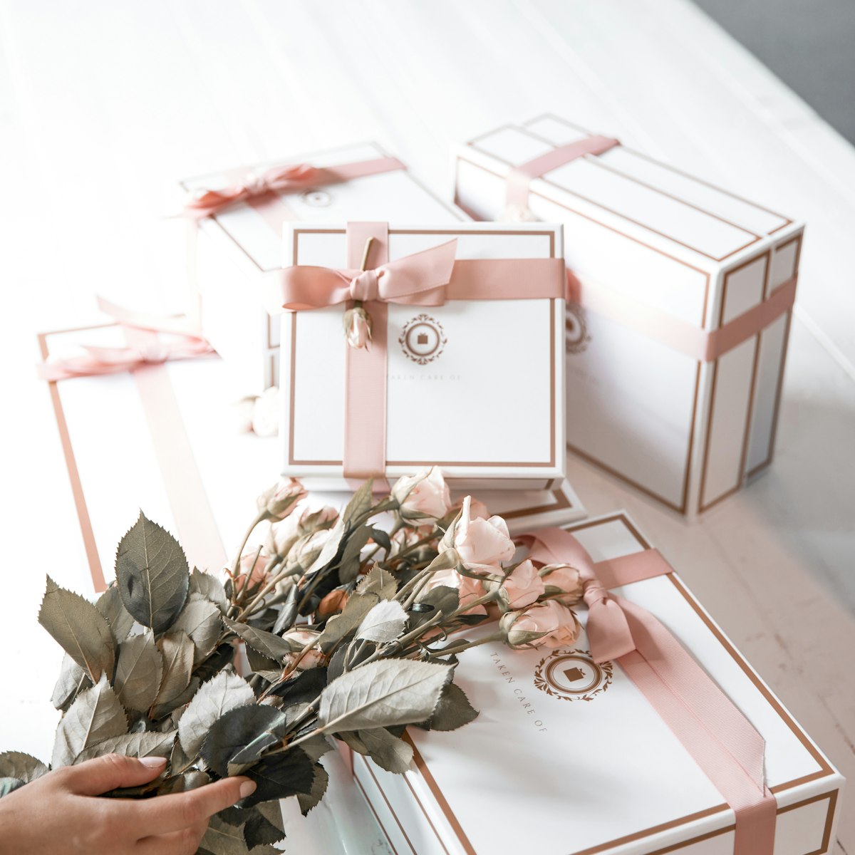 Gift boxes with pink ribbon and dried roses