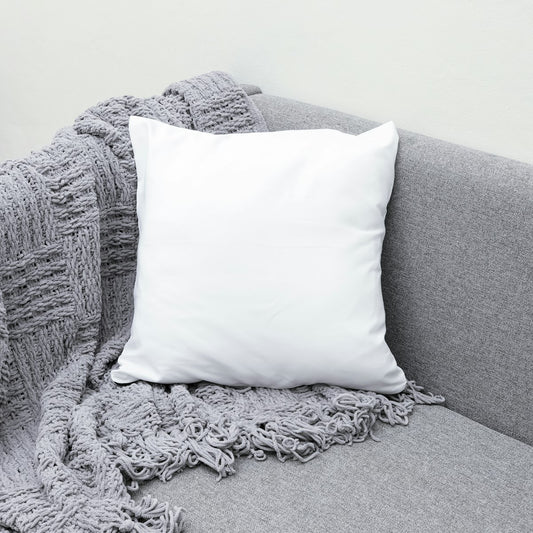 White throw pillow on a gray sofa