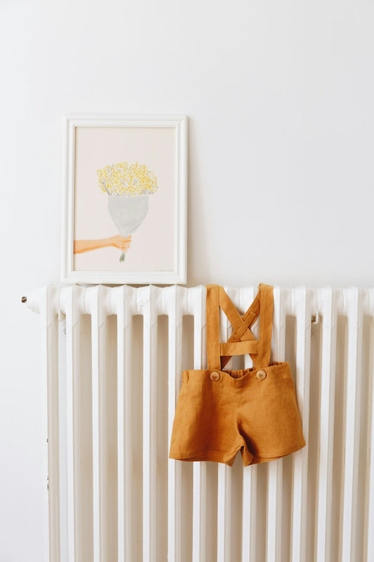 Baby's clothes hanging on a radiator